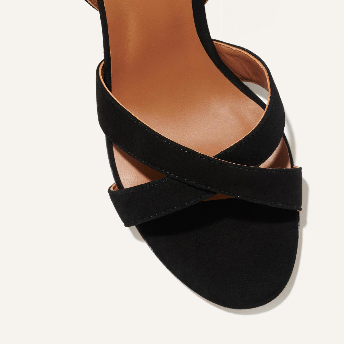 The City Sandal in Black Suede, featuring carefully placed straps, and adjustable ankle strap and a comfortable 2.5-inch block heel.