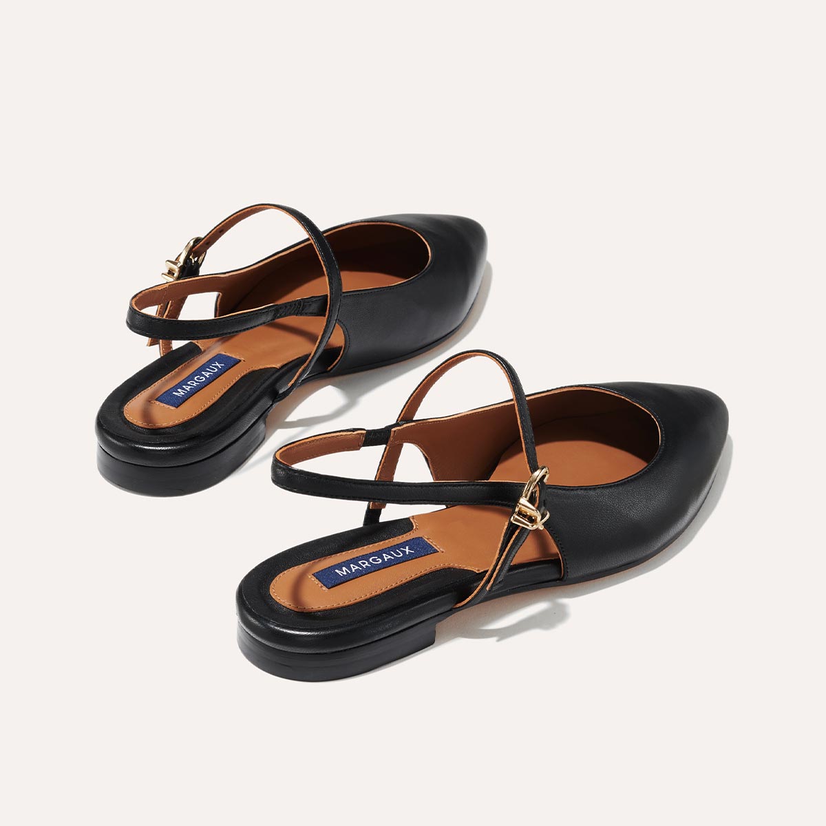 The Cluny Slingback in Black Nappa, a ballet flat with a pointed toe, a slingback strap and an adjustable strap across the top of the foot for a secure fit.