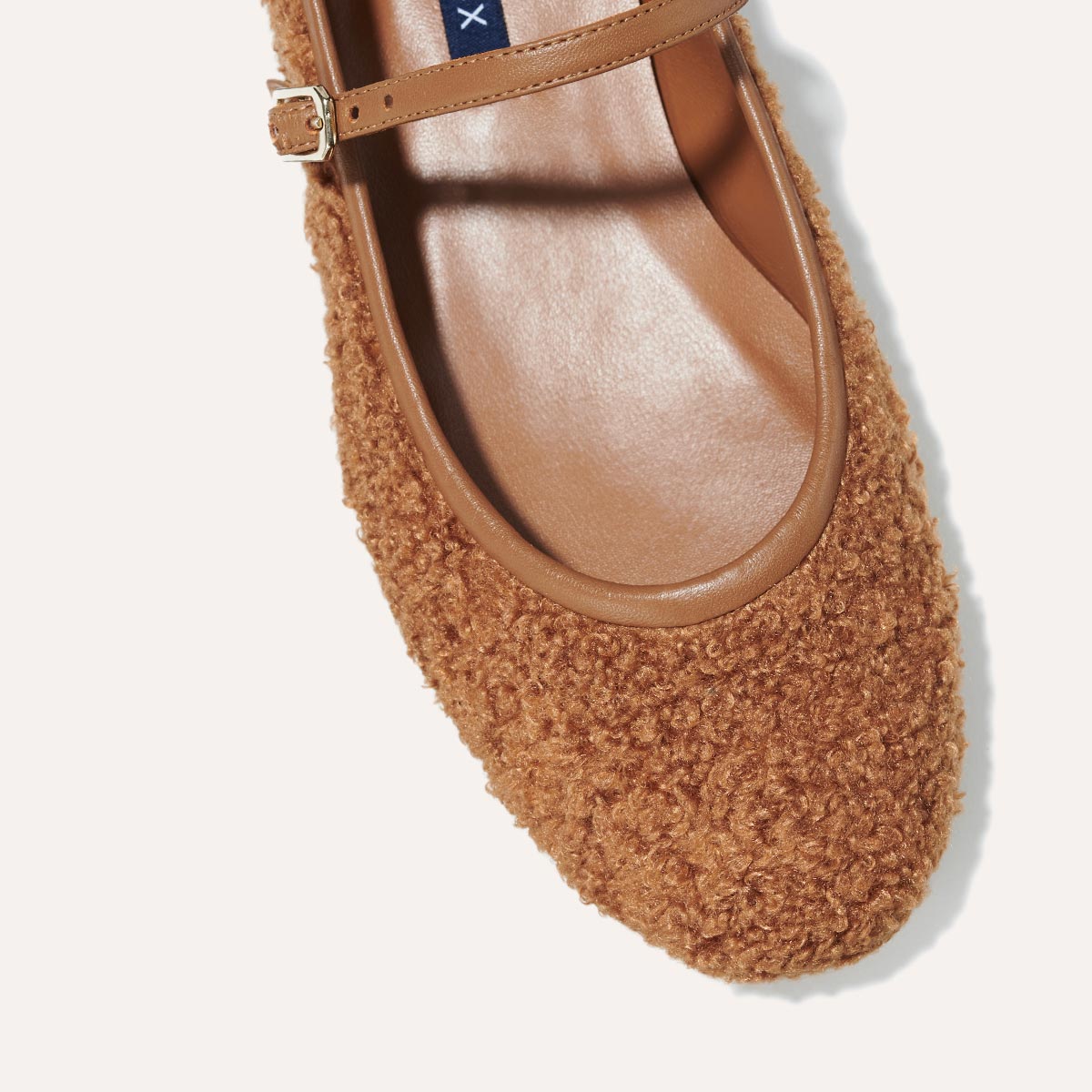The Demi Jane in brown teddy sherpa, a ballet flat with a rounded toe and an adjustable strap for a secure fit.