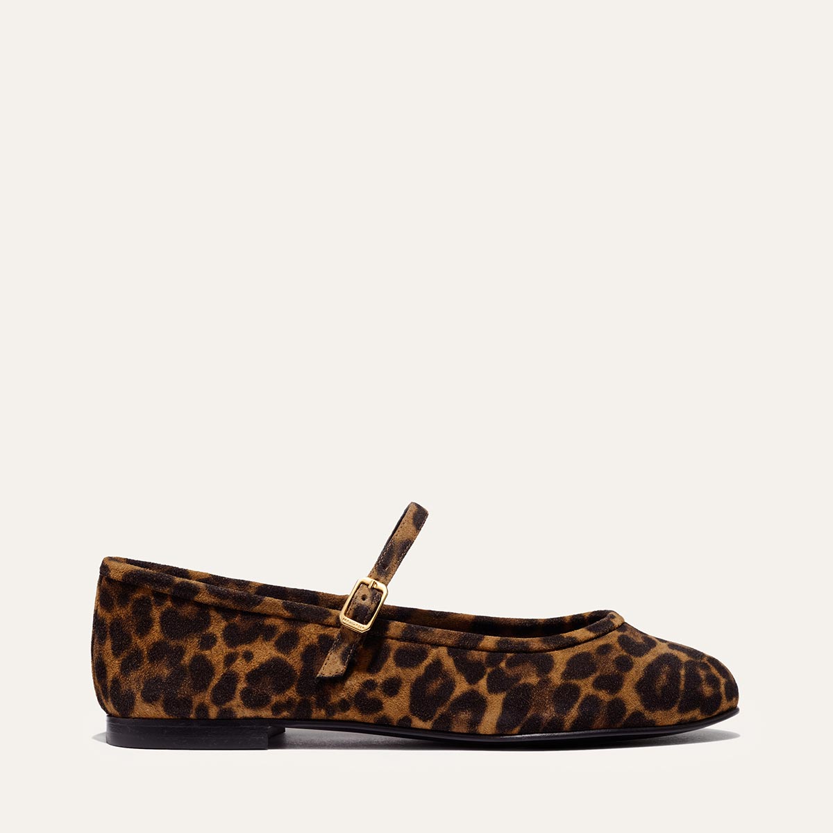 The Demi Jane - Leopard Suede by margaux-development is a single flat Mary Jane shoe in leopard print suede, featuring a thin strap with a gold buckle, exuding elegant femininity against a plain light background.