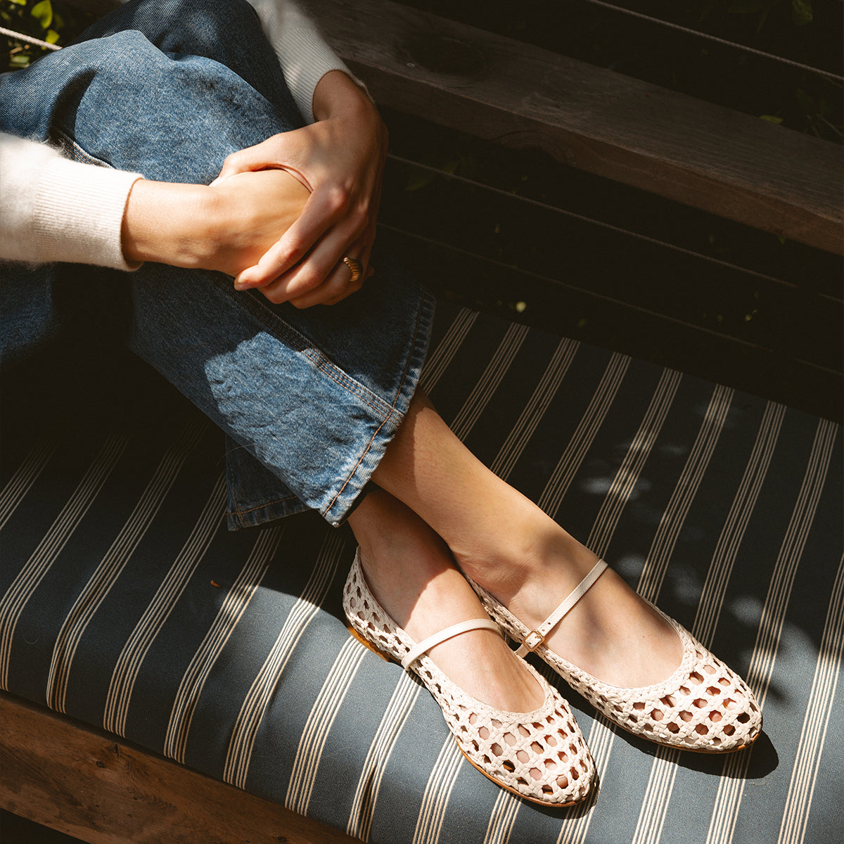A ecru woven Mary Jane flat made from handwoven leather with a classic strap.