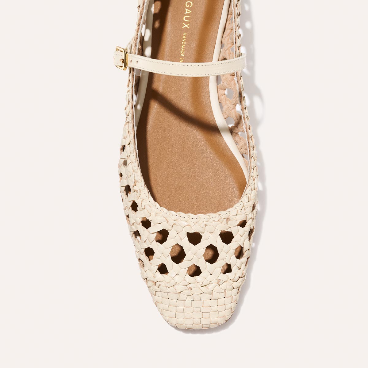 Top view of Margaux’s The Fonteyn Jane in Ecru Woven Leather: a handwoven flat ballerina with closed toe, cutout details, and adjustable ankle strap for a secure fit.