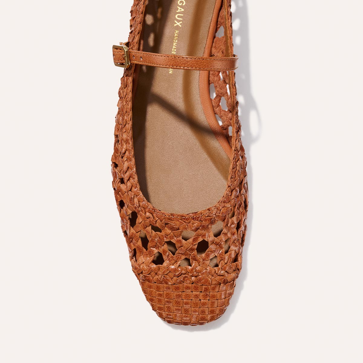 Top view of Margaux's The Fonteyn Jane - Saddle Woven Leather, a handwoven ballerina flat with a square toe, thin adjustable strap, side buckle, and intricate cutout patterns.