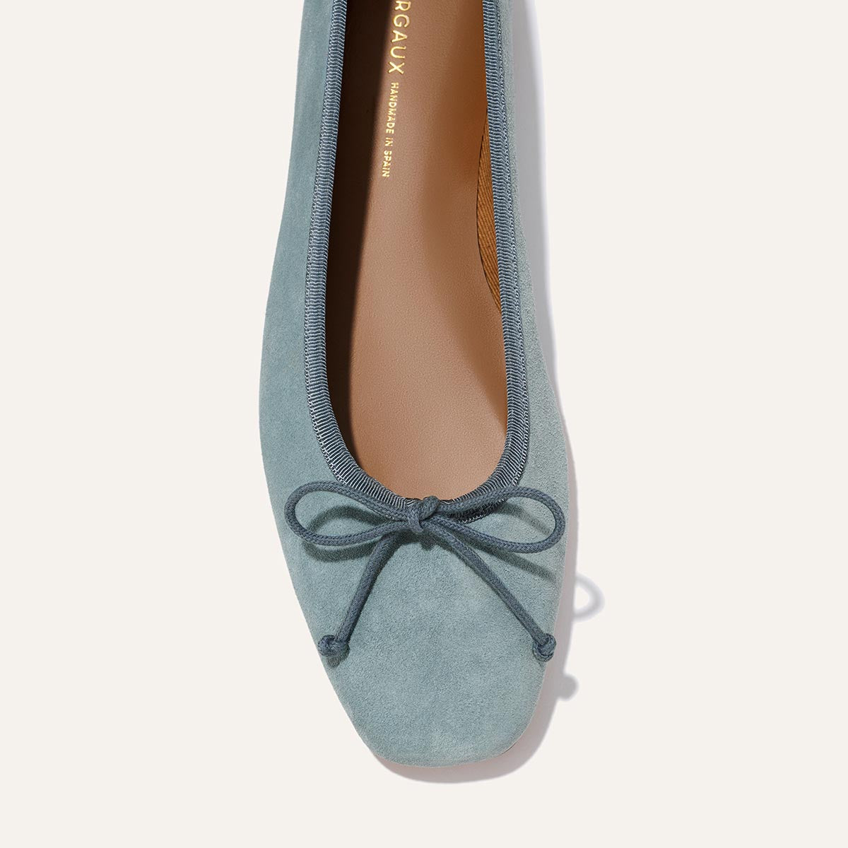 A close-up top view of Margaux’s The Fonteyn in Ocean Suede, a comfort-first ballet flat with a square toe and small front bow.