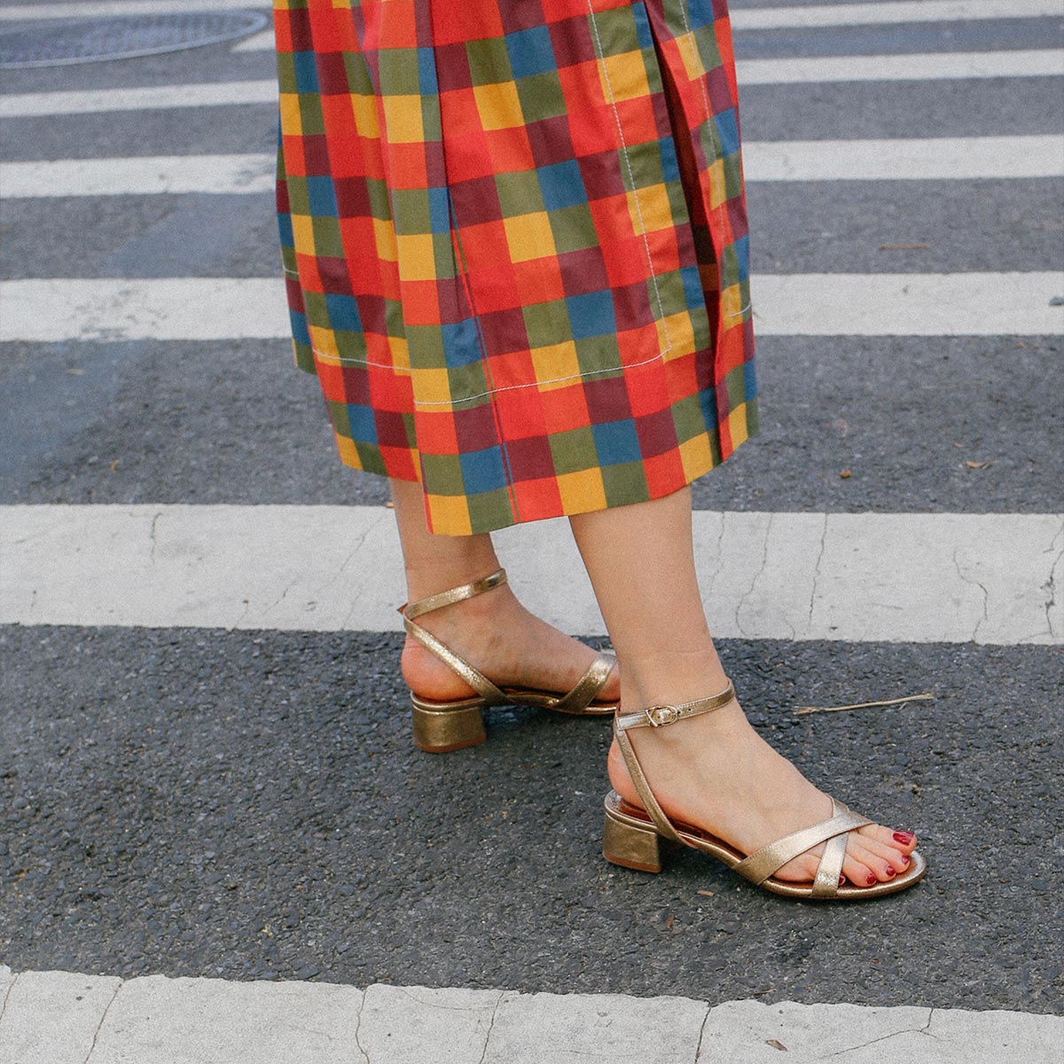 The Lena Sandal in metallic Gold Crinkle Nappa, featuring perfectly placed straps around the ankle and toes and a comfortable 1.5-inch block heel.