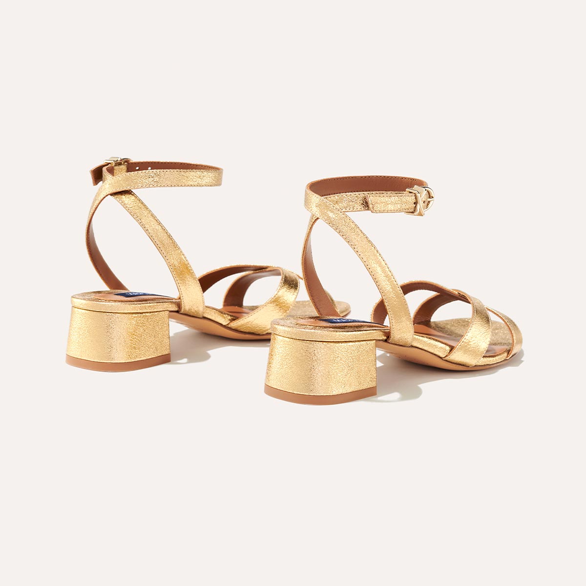 The Lena Sandal in metallic Gold Crinkle Nappa, featuring perfectly placed straps around the ankle and toes and a comfortable 1.5-inch block heel.