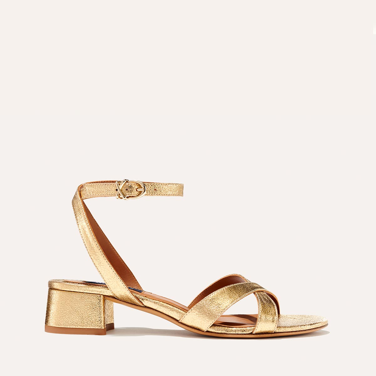 The Lena Sandal in metallic Gold Crinkle Nappa, featuring perfectly placed straps around the ankle and toes and a comfortable 1.5-inch block heel.