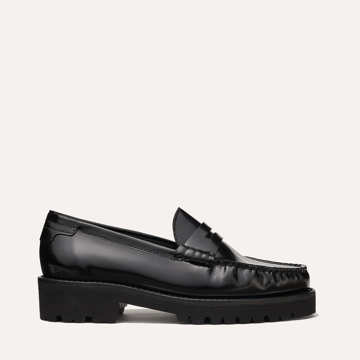 The Louisa Loafer in Black Calf, a leather penny loafer with chunky lug sole, featuring high-shine abrasivato leather and a lightweight design.