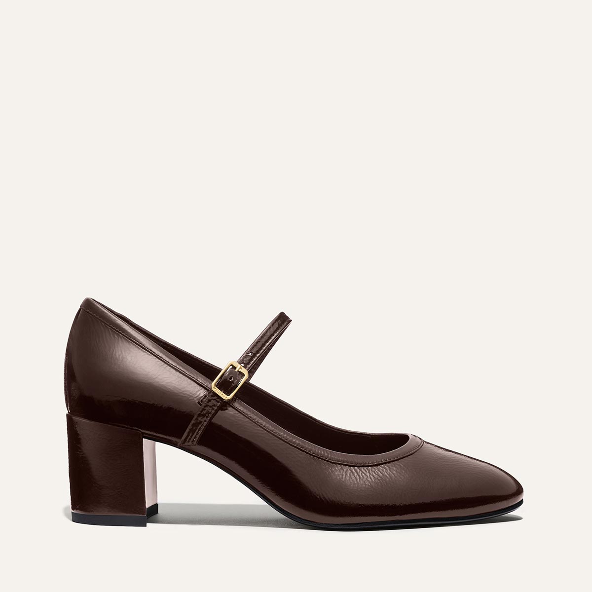 The Mira Jane - Cocoa Crinkle Patent by margaux-development: a dark brown crinkle gloss patent leather Mary Jane with a block heel and slim strap with gold buckle, shown in side profile on a light background.