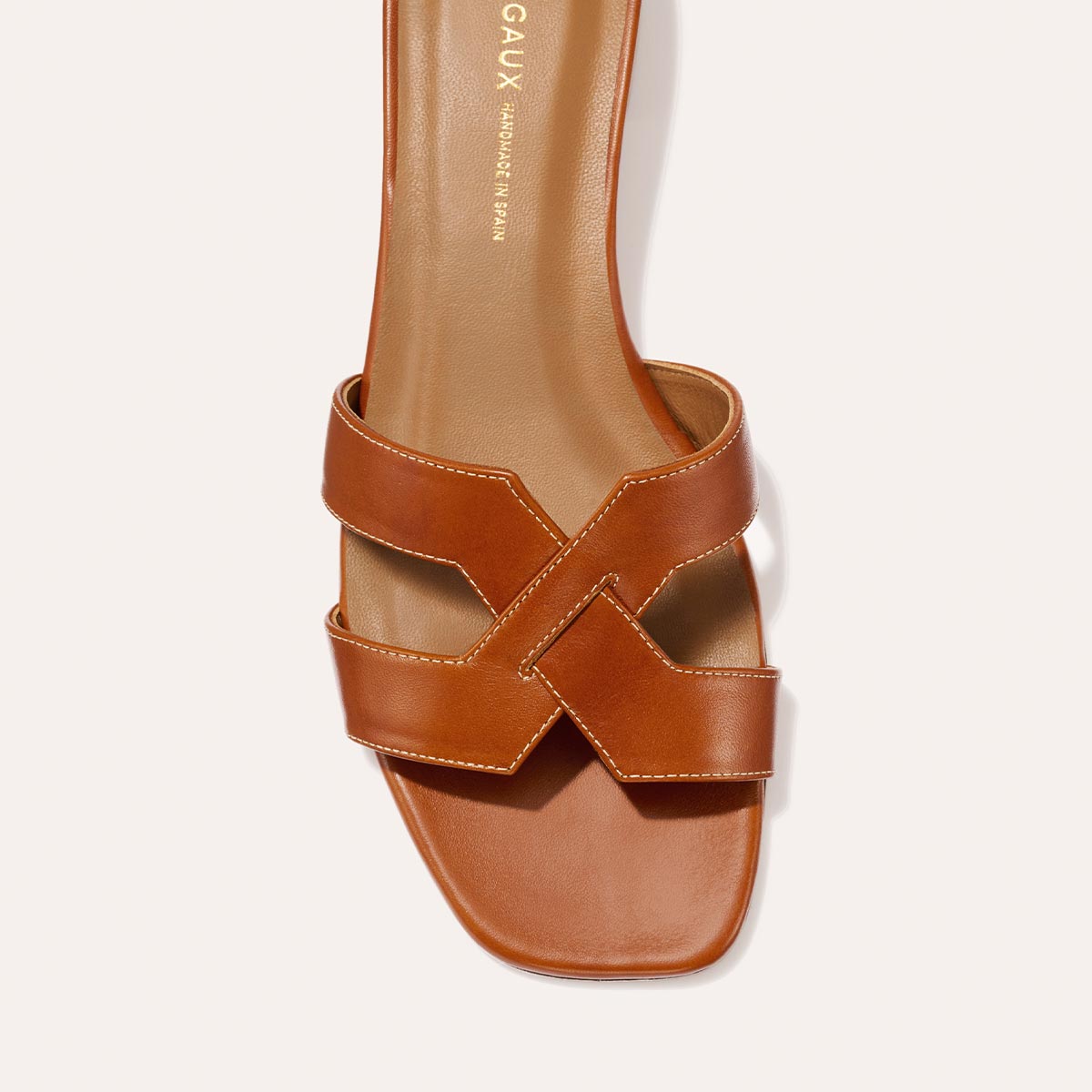 The MX 35 - Saddle Calf by Margaux-development is a brown leather sandal with a square toe, interwoven straps, visible stitching, tan insole, and a comfy block heel.