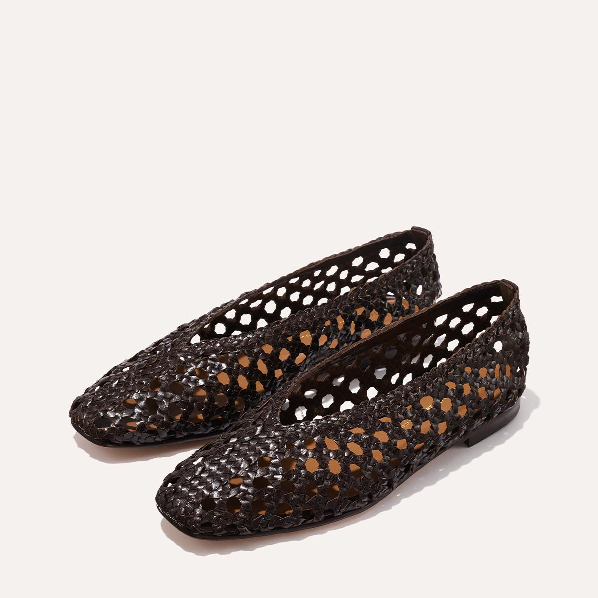 The Woven Paz - Espresso Leather by Margaux: luxurious brown handwoven flats with a lattice design, shown on a light background.