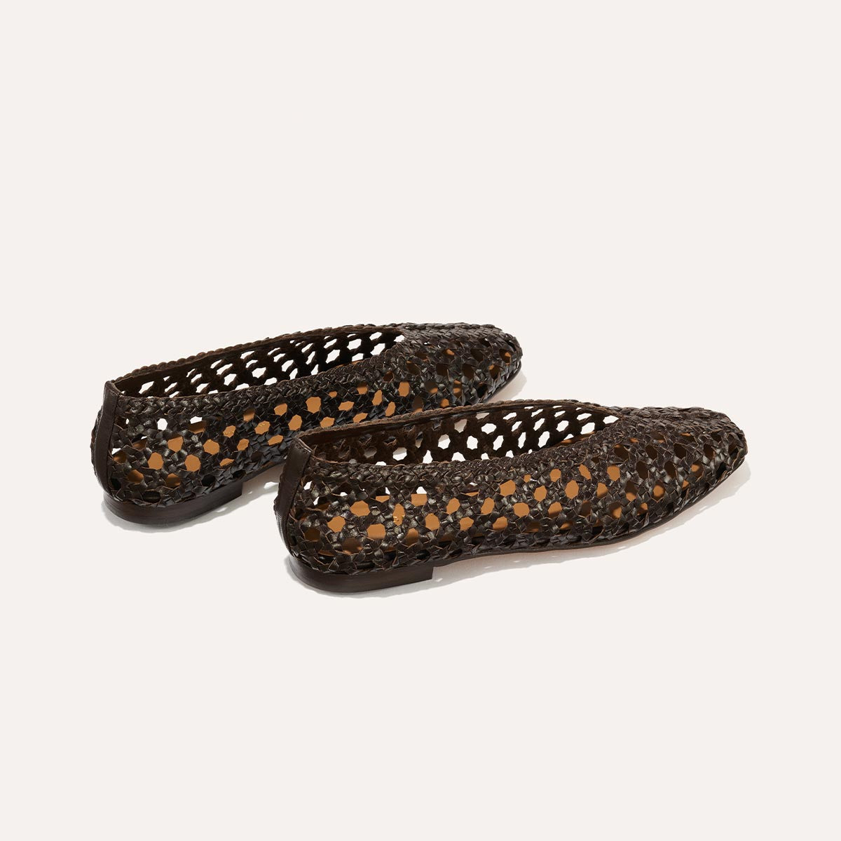 The Woven Paz - Espresso Leather flats by Margaux feature soft, handwoven dark brown leather in an open lattice design with tan insoles, shown angled on a plain light background.