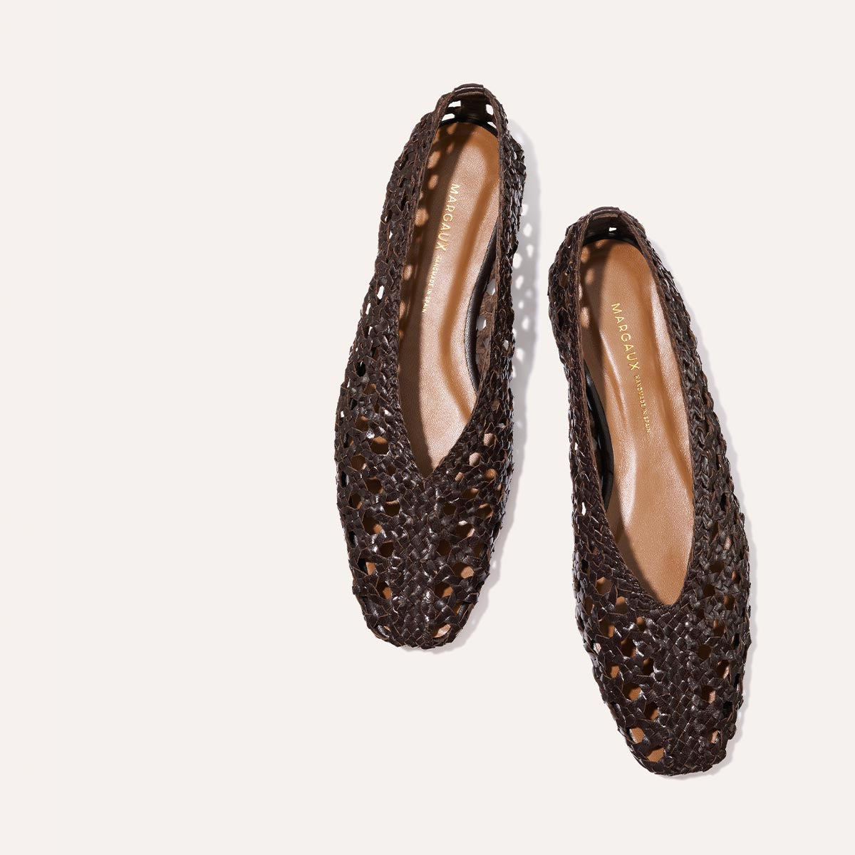The Woven Paz - Espresso Leather by Margaux: dark brown handwoven flats with pointed toes, low heel, and cut-out details, shown on a light background.