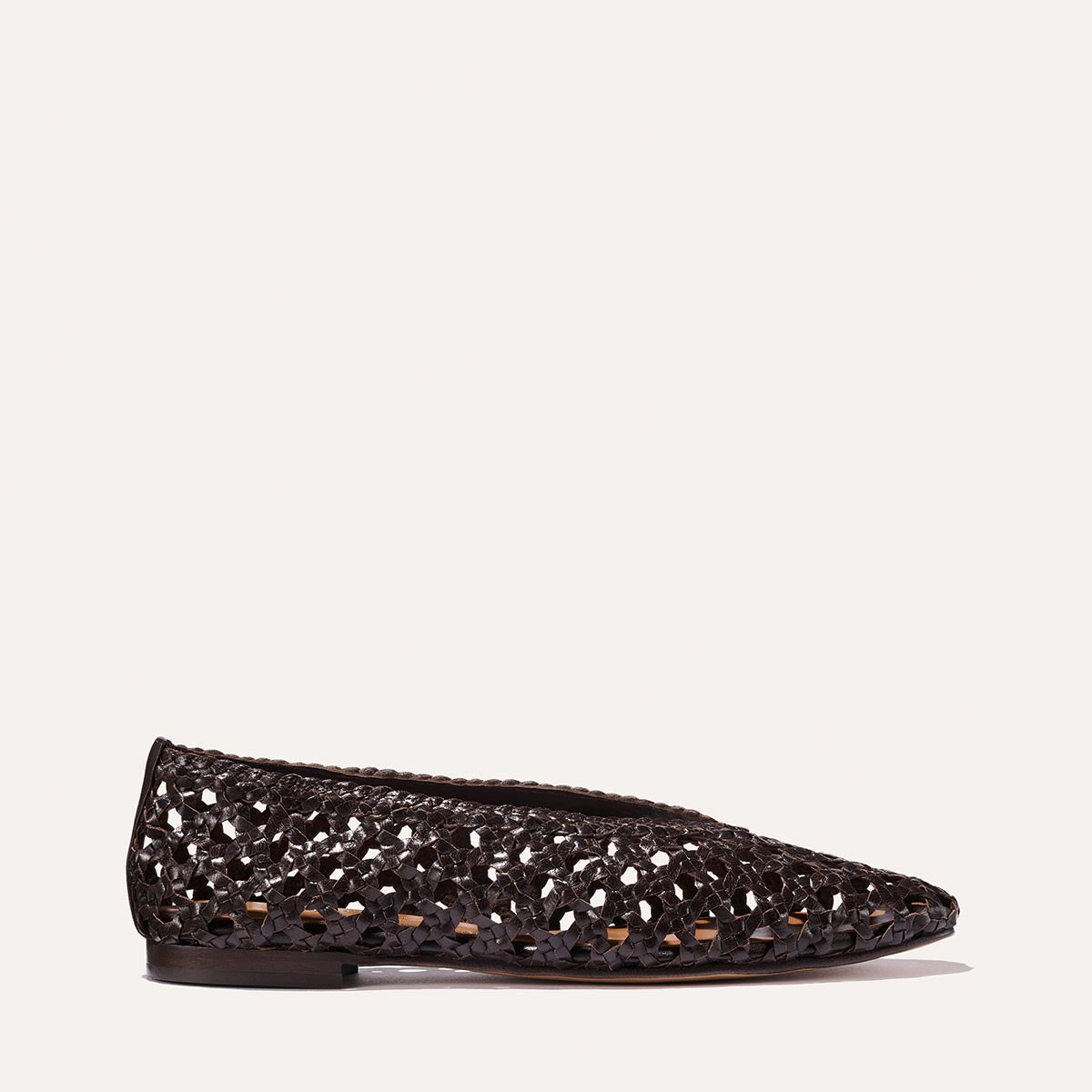 The Woven Paz - Espresso Leather by Margaux: a single flat shoe in rich black leather, featuring a pointed toe and intricate handwoven cutouts, displayed against a plain light background.