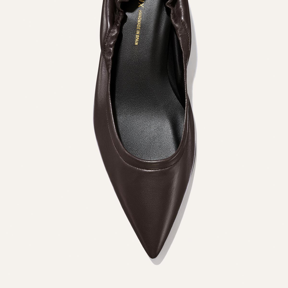 Top view of The Roma 40 - Espresso Nappa by Margaux, a dark brown pointed-toe flat leather shoe with gathered detail at the heel, displayed on a light background.
