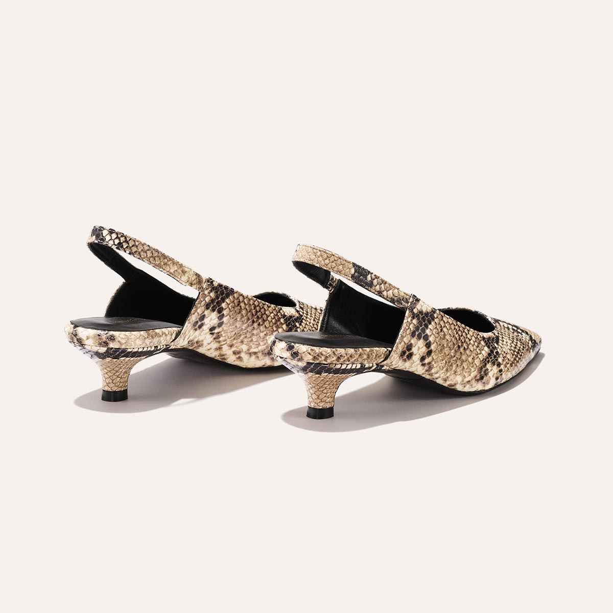 The Sofia Sling - Natural Python Embossed by Margaux features a snip toe and kitten heel in a brown snake print, shown against a light background.