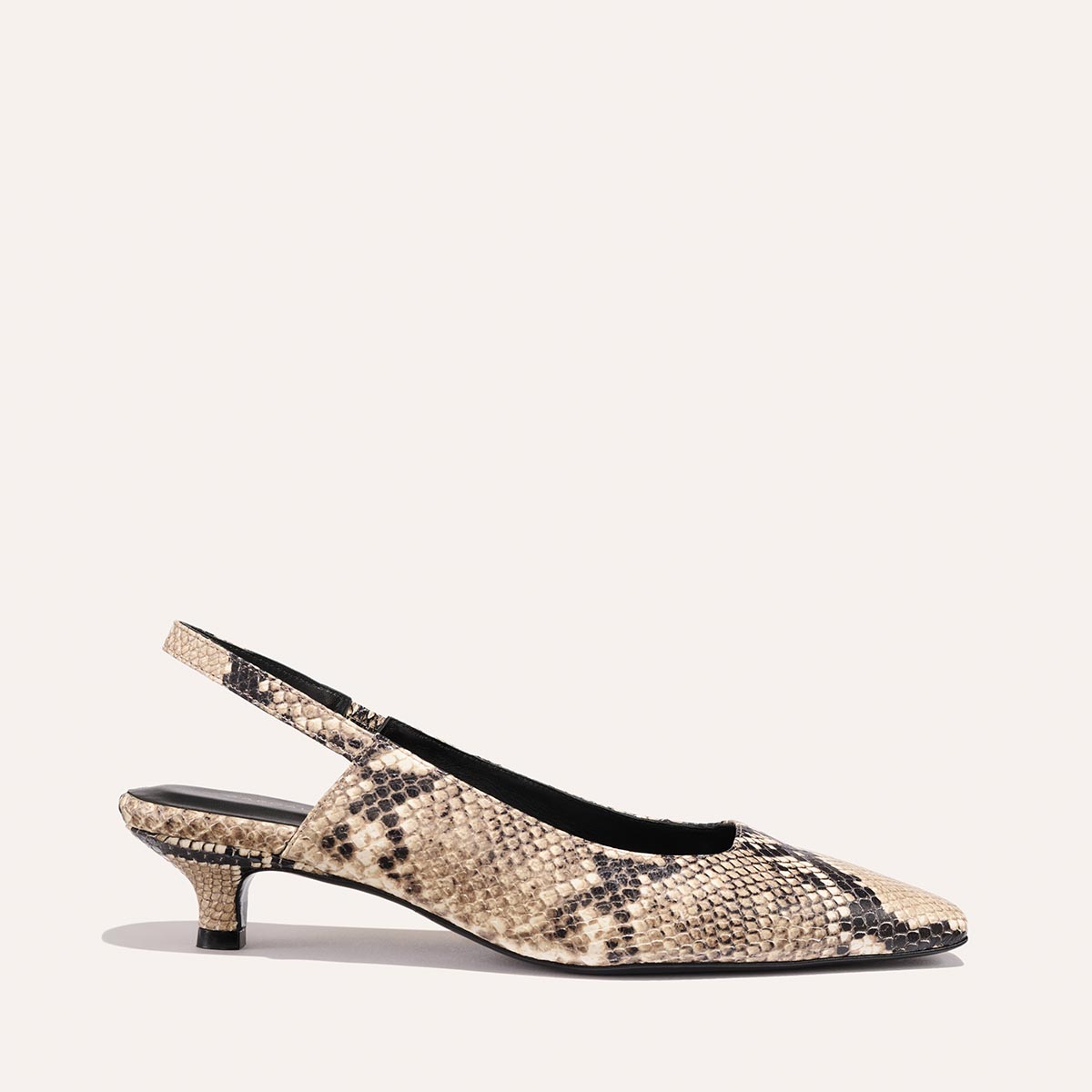 The Sofia Sling - Natural Python Embossed by Margaux is a beige and black faux snakeskin slingback pump with a snip nose, low micro heel, and pointed toe, shown on a plain light background.