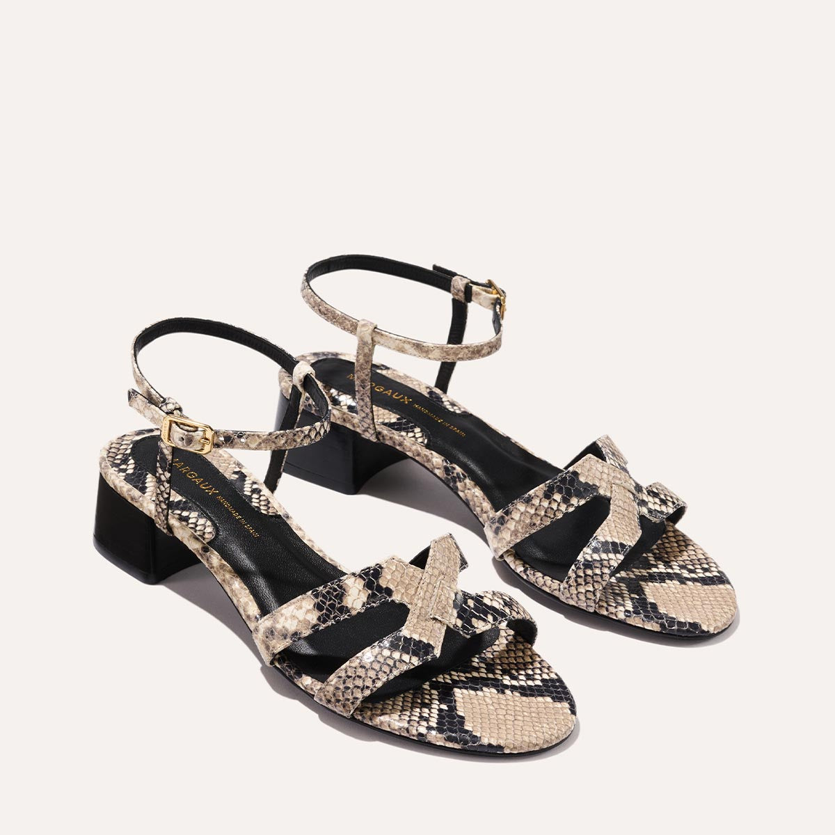 Low heeled sandals shown in natural embossed python