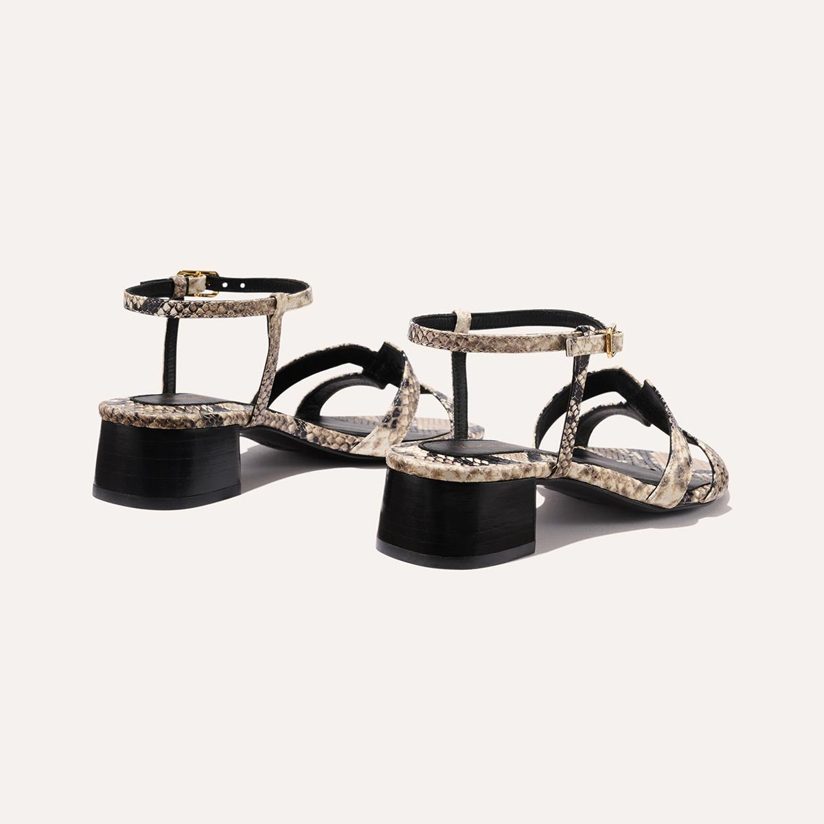 Low heeled sandals shown in natural embossed python