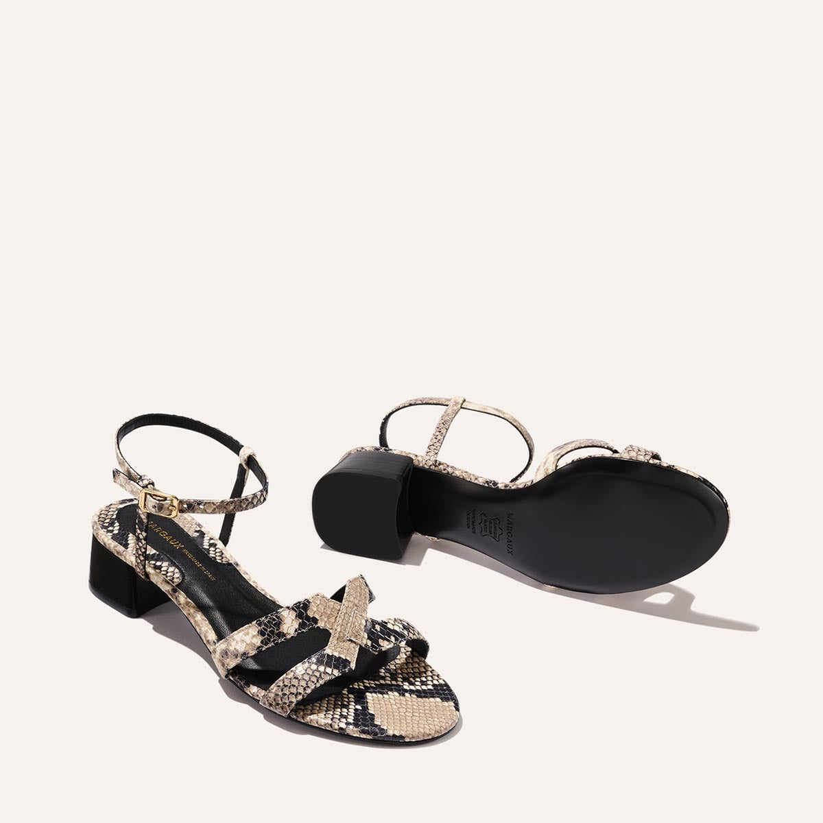 Low heeled sandals shown in natural embossed python