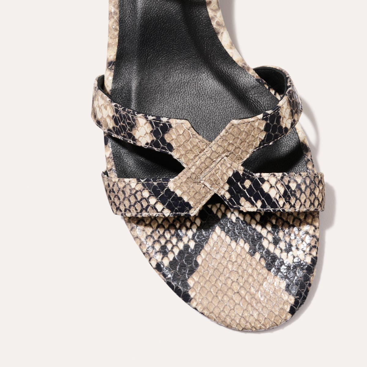 Low heeled sandals shown in natural embossed python