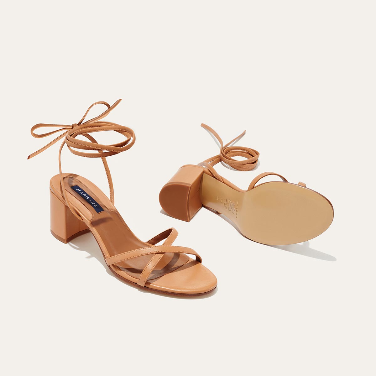 The Soho Sandal in Desert Nappa, featuring thin, flattering straps with a delicate ankle wrap, and a comfortable 2.5-inch block heel.