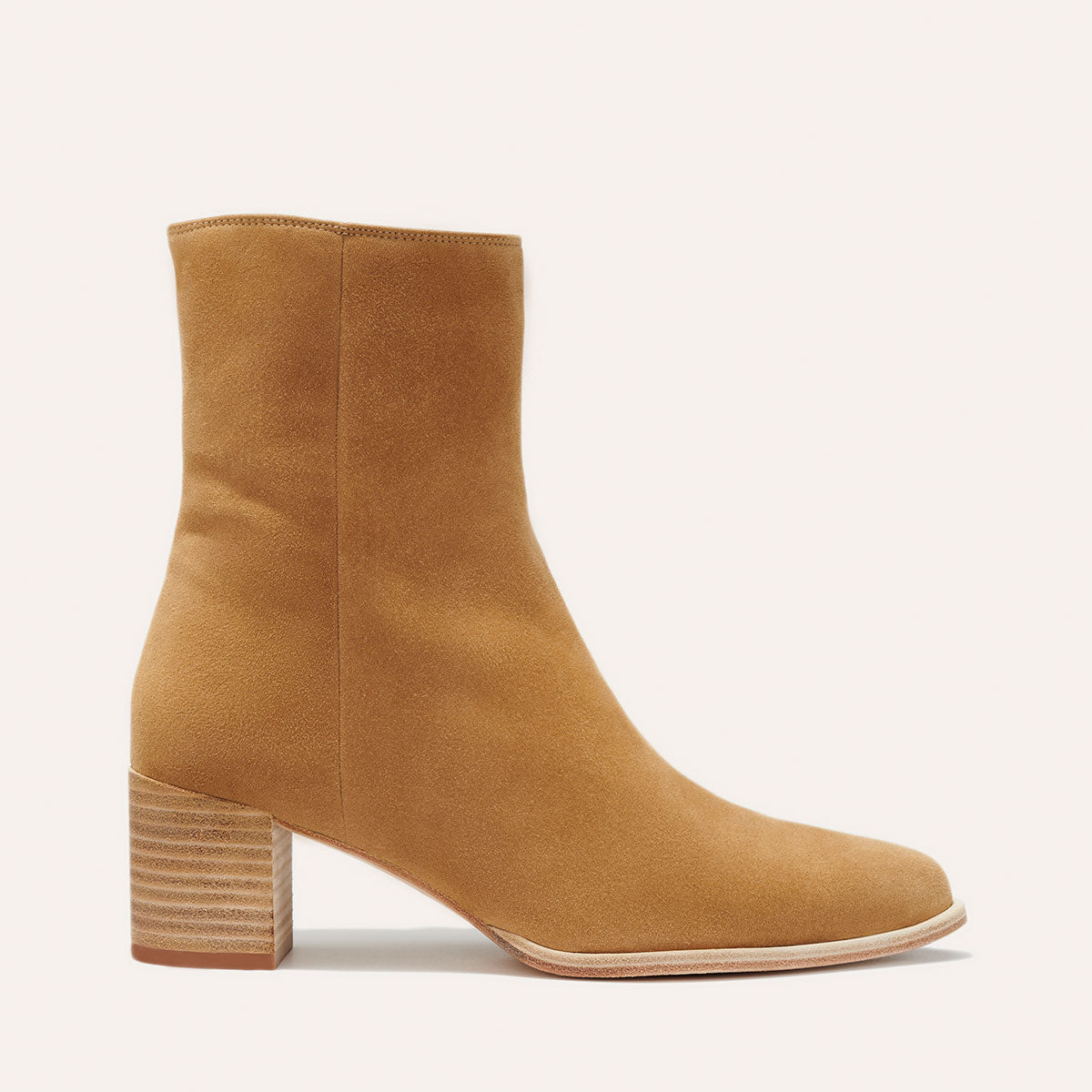 Margaux's classic Downtown Boot in beige suede with a comfortable block heel and pointed toe