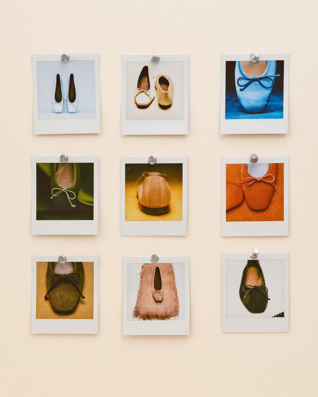 Nine polaroid photos of various single shoes are pinned to a beige wall in a 3x3 grid. Each photo shows a different style, color, and background, highlighting unique shoe designs.