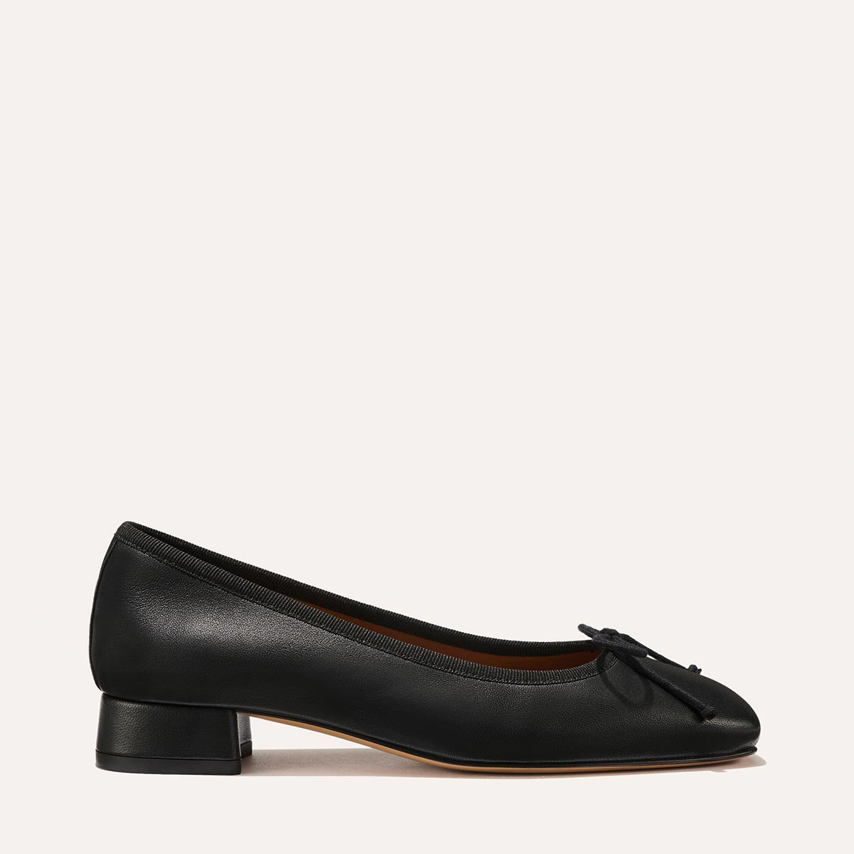 The Ada in Black Nappa, a comfortable ballet flat with a square toe, adjustable cord bow detail, and comfortable 1-inch block heel.