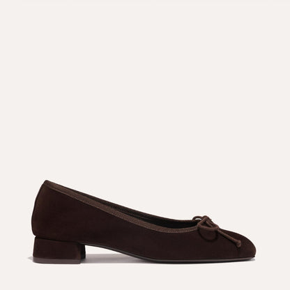 The Ada - Espresso Suede by margaux-development is a dark brown suede ballet pump with a rounded toe, low heel, and small front bow, crafted for a glove-like fit and displayed on a plain light background.