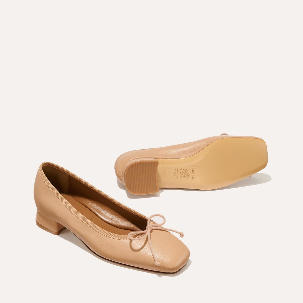 The Ada in Dune Nappa, a comfortable ballet flat with a square toe, adjustable cord bow detail, and comfortable 1-inch block heel.