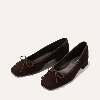 The Ada - Espresso Suede by margaux-development: dark brown suede ballet flats with square toes, low block heels, bow detail, and sacchetto construction for a glove-like fit, shown on a light background.