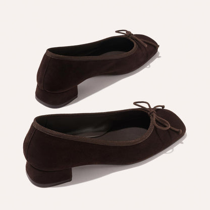 The Ada - Espresso Suede by margaux-development: dark brown suede low-heeled ballet pumps with small bows on rounded toes and a glove-like fit from sacchetto construction, displayed on a light background.