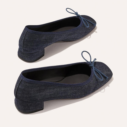 The Ada - Indigo Denim by margaux-development: classic dark blue denim ballet pumps with low heels, rounded toes, and matching bow accents, shown on a light background.