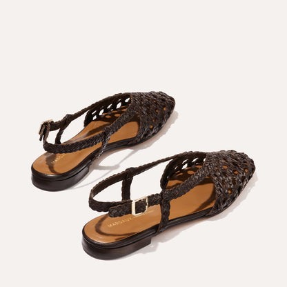 The Altea - Espresso Woven Leather flats by Margaux feature woven dark brown leather, pointed toes, braided straps, and gold buckles—ideal for effortless summer style—shown against a light background.