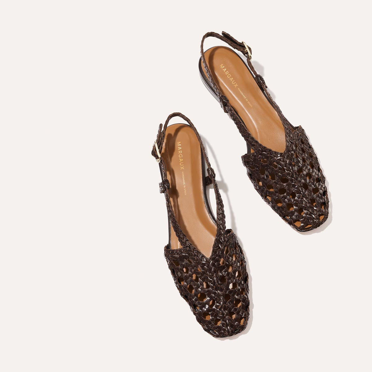 The Altea - Espresso Woven Leather flats by Margaux feature dark brown woven leather, pointed toes, and adjustable slingback straps—ideal for effortless summer style, shown on a light background.