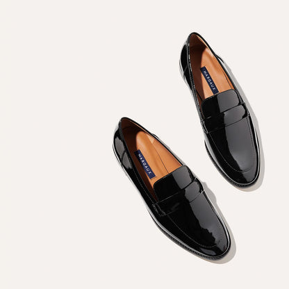 The Andie Loafer in shiny Black Patent, featuring a sleek structured design made from smooth Italian nappa leather with a minimalistic padded keeper detail.
