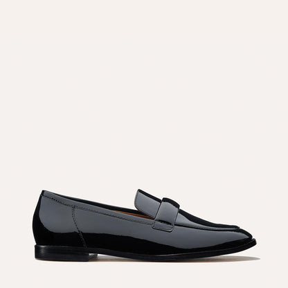 The Andie Loafer in shiny Black Patent, featuring a sleek structured design made from smooth Italian nappa leather with a minimalistic padded keeper detail.
