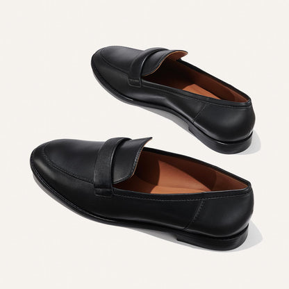The Andie Loafer in Black Nappa, featuring a sleek structured design made from smooth Italian nappa leather with a minimalistic padded keeper detail.