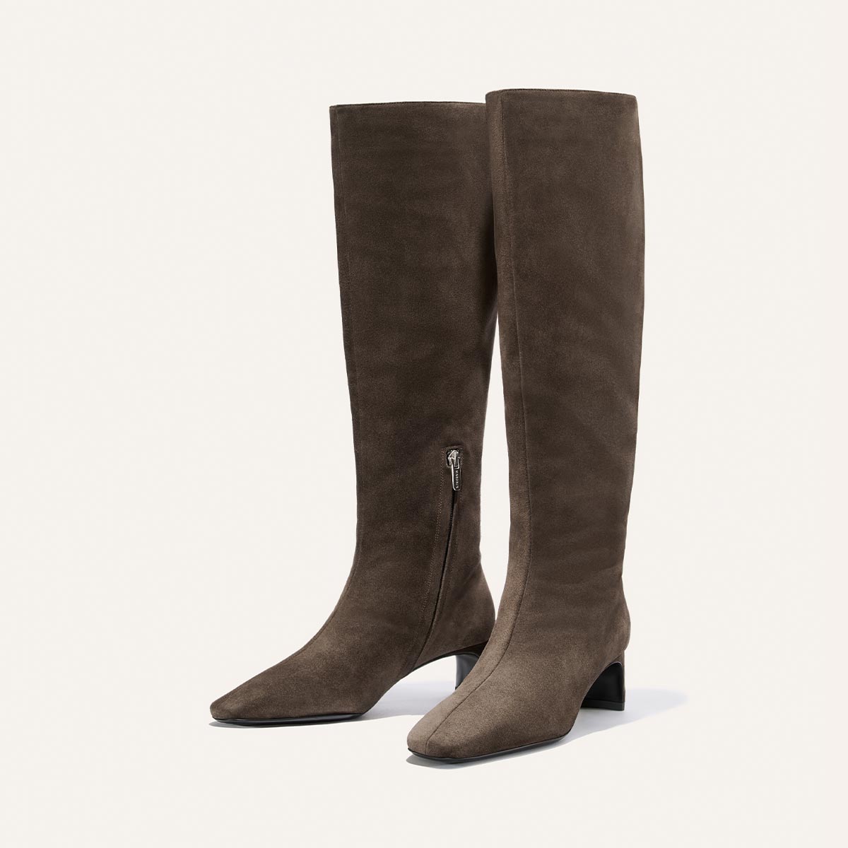 The Brera Knee-High Boot by Margaux, shown in English Brown Suede, features a comfortable mid-height block heel, side zippers for easy wear, and a padded insole for enhanced comfort, all displayed against a plain white background.