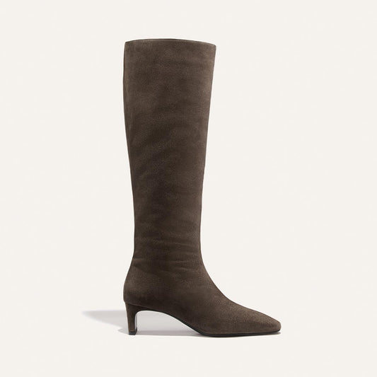 The Brera Knee-High Boot in English Brown Suede by Margaux, featuring a pointed toe and a low, walkable heel, is shown against a plain light background.