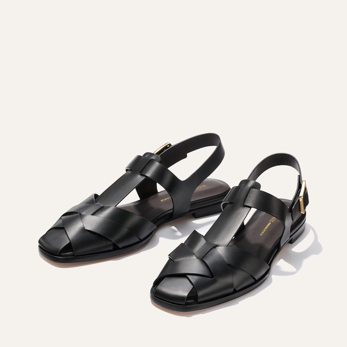 Pair of black sandals on a light gray background