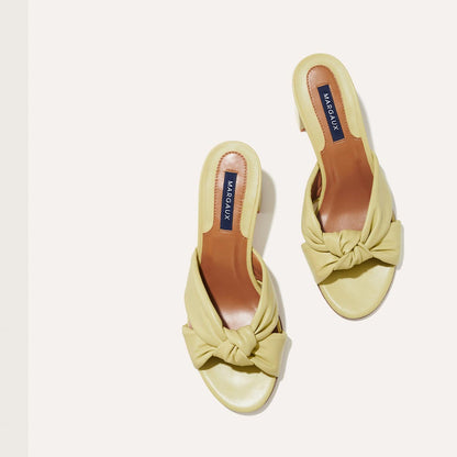 The Carmine Mule in Pear Nappa, a slide-on heel featuring a plush knot detail and comfortable 2.5-inch block heel