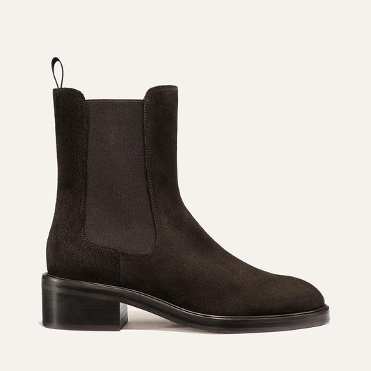The City Chelsea Boot - Dark Chocolate Suede by Margaux, featuring a block heel, elastic side panels, a back pull tab, and a smooth sole, is displayed on a neutral background.