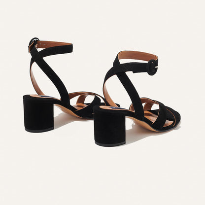 The City Sandal in Black Suede, featuring carefully placed straps, and adjustable ankle strap and a comfortable 2.5-inch block heel.