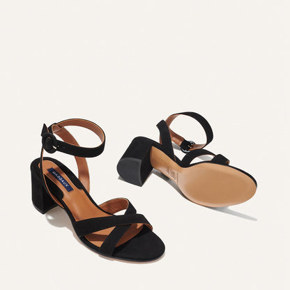 The City Sandal in Black Suede, featuring carefully placed straps, and adjustable ankle strap and a comfortable 2.5-inch block heel.
