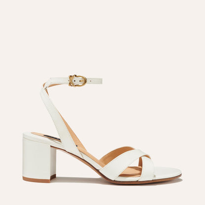 The City Sandal in Ivory Nappa, featuring carefully placed straps, and adjustable ankle strap and a comfortable 2.5-inch block heel.