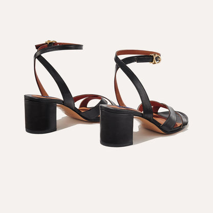 The City Sandal in Black Nappa, featuring carefully placed straps, and adjustable ankle strap and a comfortable 2.5-inch block heel.