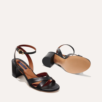 The City Sandal in Black Nappa, featuring carefully placed straps, and adjustable ankle strap and a comfortable 2.5-inch block heel.