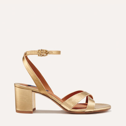 The City Sandal in metallic Gold Nappa, featuring carefully placed straps, and adjustable ankle strap and a comfortable 2.5-inch block heel.